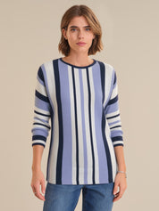 Woman wearing a blue and white striped sweater against a beige background