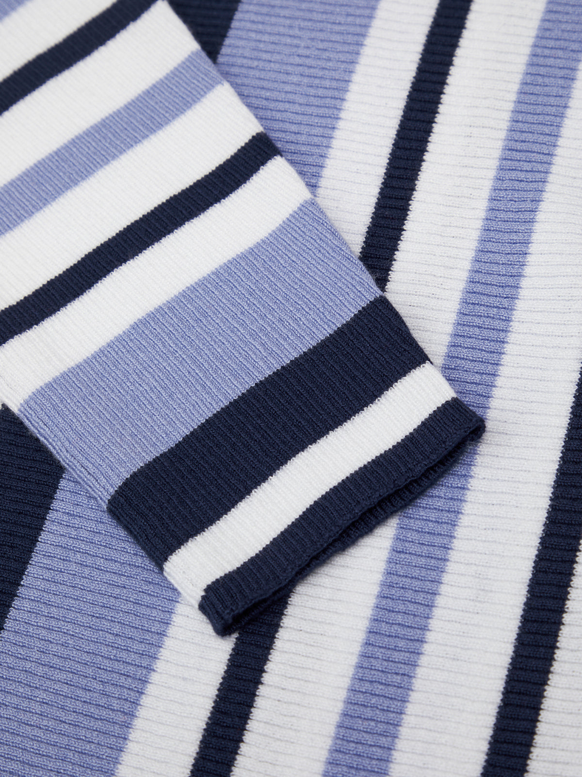 Close-up of a blue and white striped fabric with a focus on the pattern.
