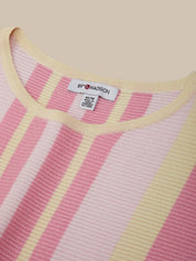 Close-up of a pink and yellow striped sweater with a brand label on a beige background