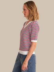 Woman wearing a striped shirt with a beige background