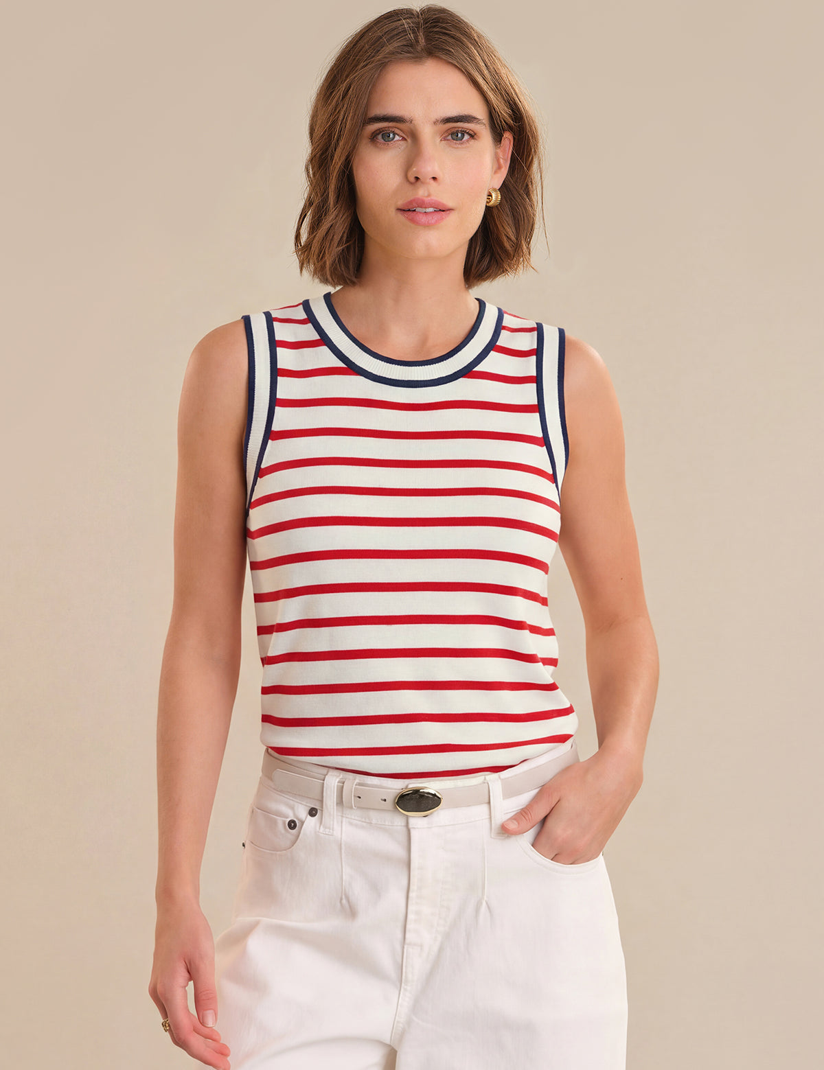 Woman wearing a red and white striped tank top against a beige background