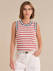 Woman wearing a red and white striped tank top against a beige background