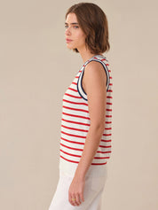 Woman wearing a red and white striped sleeveless top against a beige background