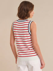 Woman wearing a red and white striped sleeveless top on a beige background