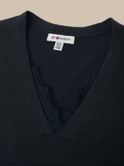 Black garment with a visible brand label on a beige background