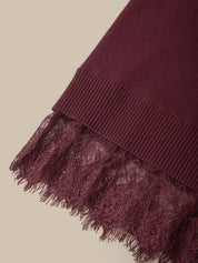 Close-up of a burgundy knit fabric with a wide ribbed cuff and a matching lace trim with frayed edges, shown on a light beige background.