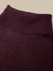 Close-up of a ribbed knit turtleneck sweater in a deep burgundy or plum purple color, showing the texture and ribbed collar against a solid beige background.