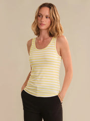 Woman wearing a yellow striped tank top against a beige background
