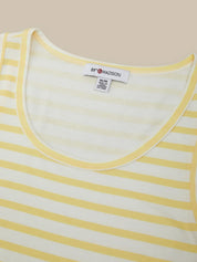 Close-up of a yellow and white striped shirt with a brand label on a beige background