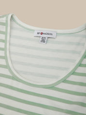 Close-up of a green and white striped shirt with a brand label on a beige background