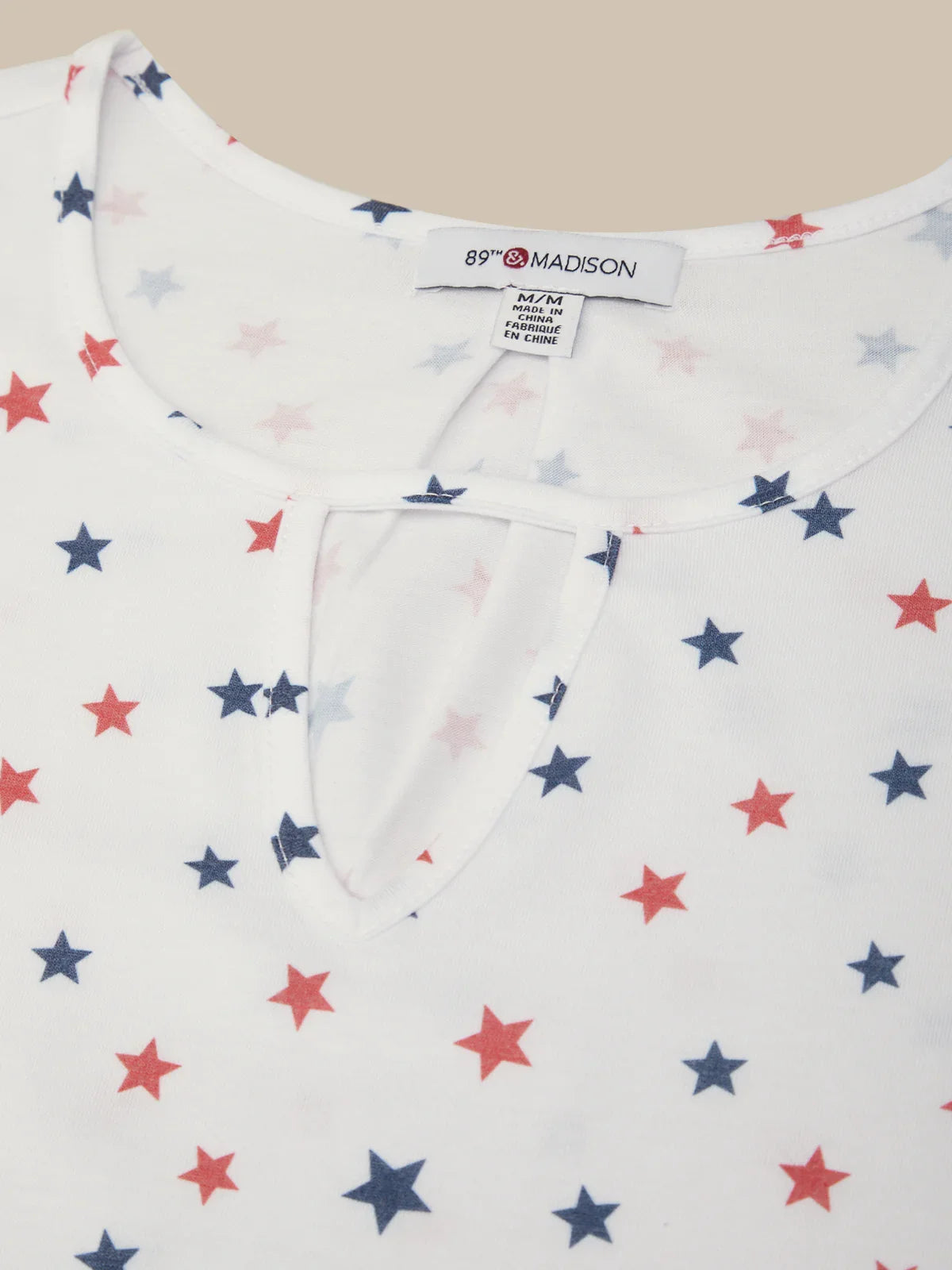 Baby onesie with star pattern on a plain background