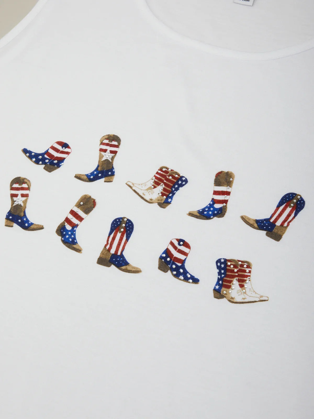 White t-shirt with red, white, and blue cowboy boot designs on a plain background