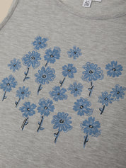 Gray t-shirt with blue floral patterns on a plain background