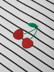 Embroidered cherries on a black and white striped fabric