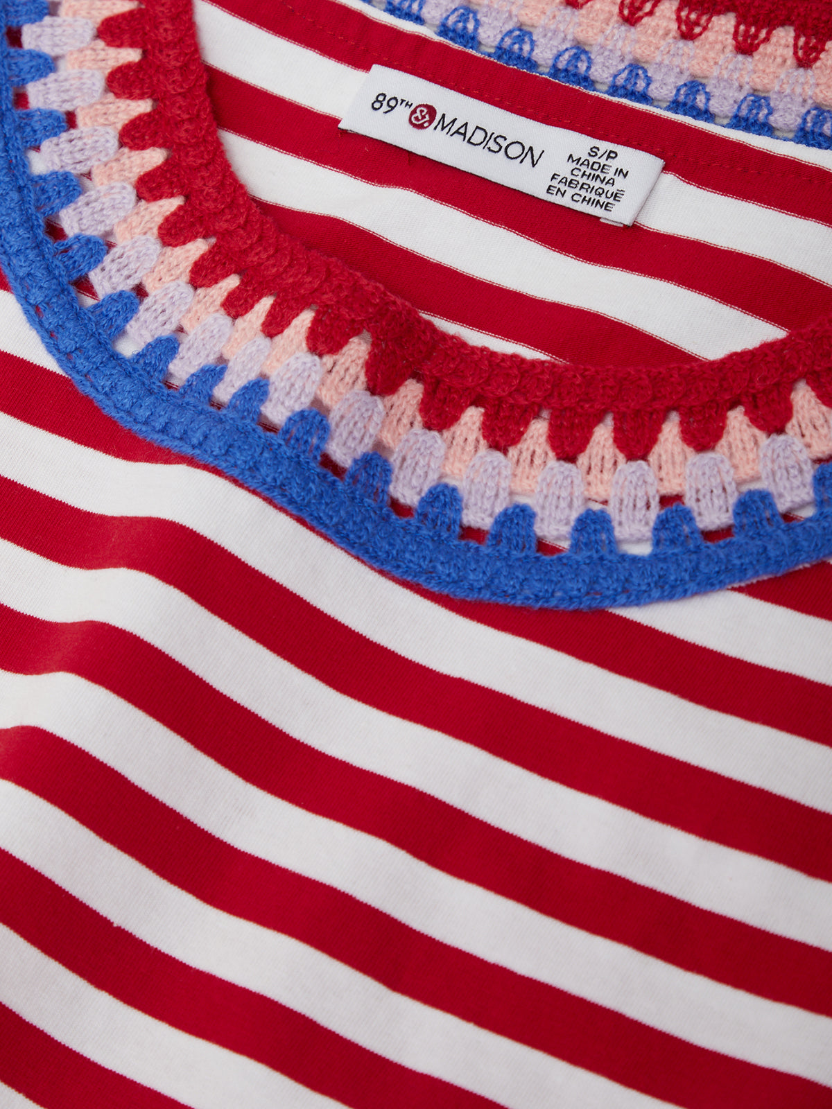 Close-up of a red, white, and blue striped garment with 'Madison' label.