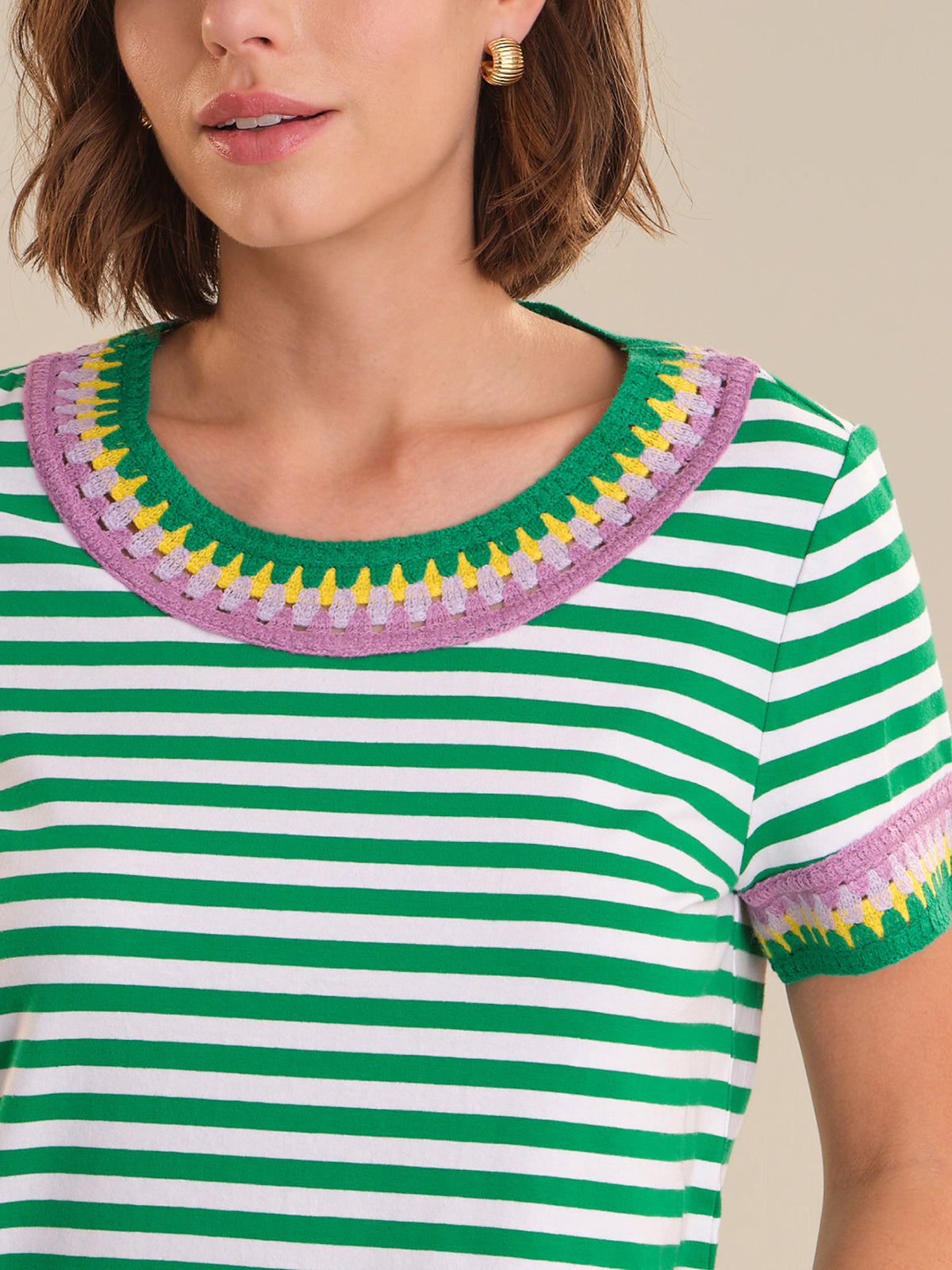 Green and white striped shirt with colorful trim worn by a person