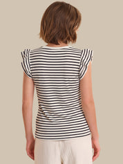 Woman wearing a black and white striped shirt against a beige background