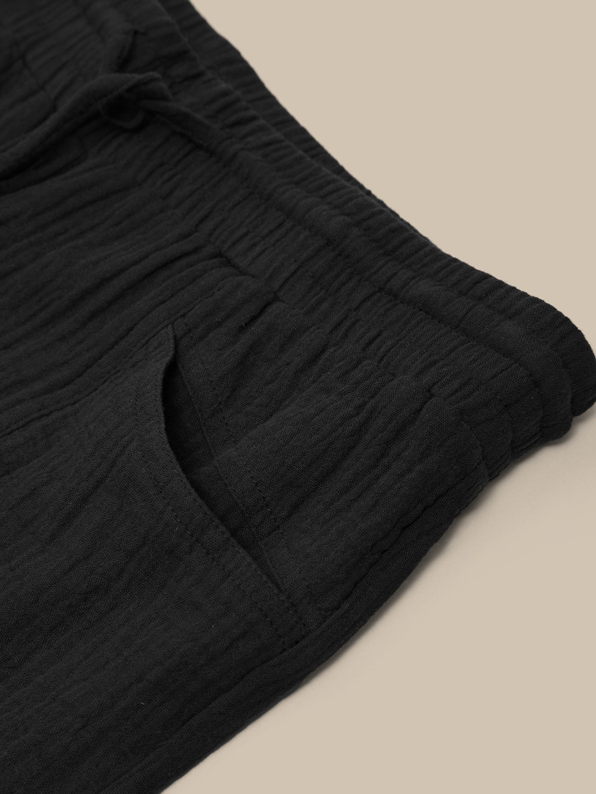 Close-up of black fabric on a beige background