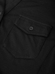 Close-up of a black jacket with a pocket and button detail