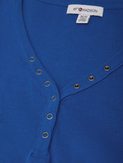 Close-up of a blue garment with button details and a visible brand label.