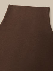 Close-up of a dark brown knit fabric, showing the texture and color of the material against a neutral beige background.