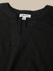 Black garment with brand label on a beige background