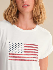 Person wearing a white t-shirt with an American flag design.
