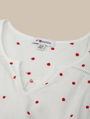 White top with red polka dots and 'Madison' brand label on a beige background
