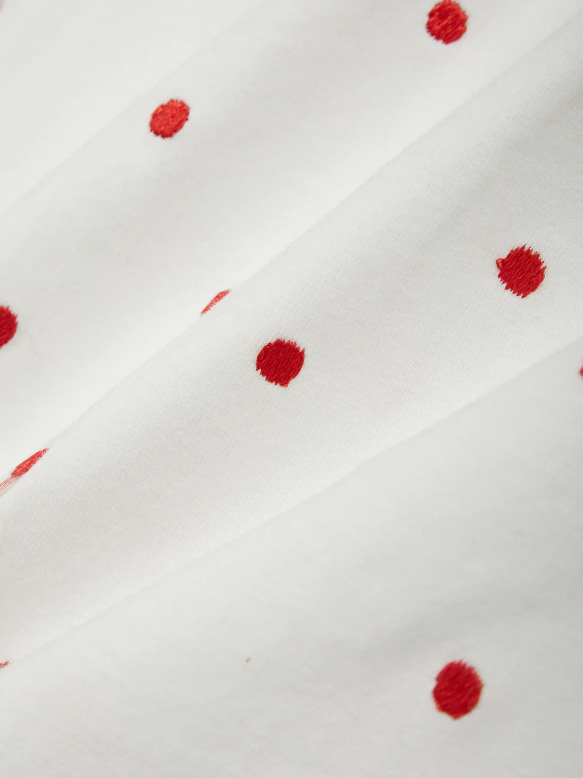 White fabric with red floral patterns