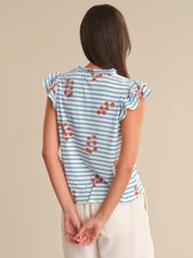 Woman wearing a blue and white striped top with red floral patterns on a beige background