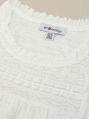 Close-up of a white textured fabric with a brand label on a beige background