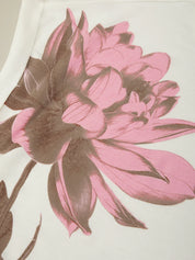 Close-up of pink and brown floral design on a fabric texture background