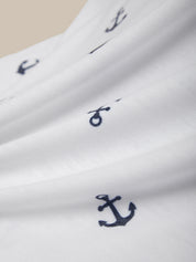 White fabric with navy blue anchor patterns