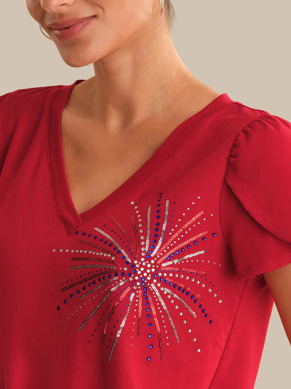 Red top with a decorative design on a neutral background