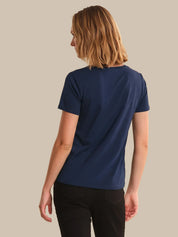 Person wearing a blue t-shirt on a beige background