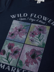 Navy blue t-shirt with floral design and text on a plain background
