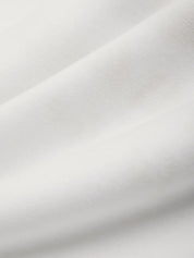 Close-up of a textured white fabric surface