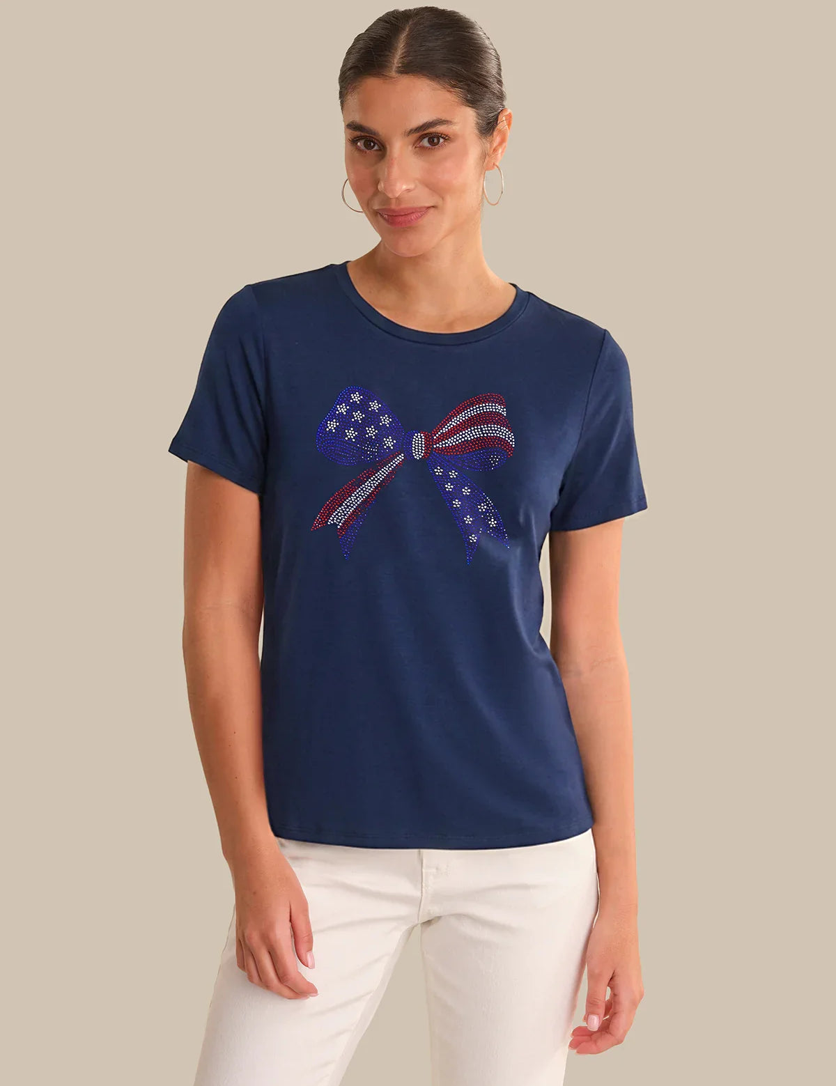 Woman wearing a navy blue t-shirt with a graphic design on a beige background