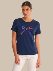 Woman wearing a navy blue t-shirt with a graphic design on a beige background