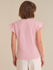 Woman wearing a red and white striped shirt with ruffled sleeves on a beige background