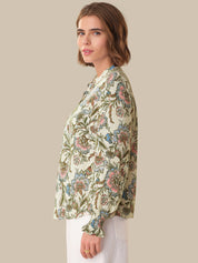 Woman wearing a floral blouse with a beige background