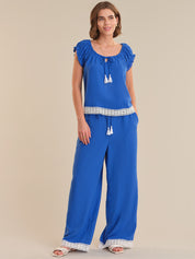 Woman wearing a blue outfit with a plain background