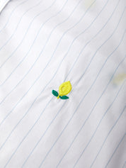 Embroidered lemon design on a white shirt with blue pinstripes
