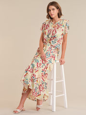 Woman wearing a colorful floral dress on a beige background