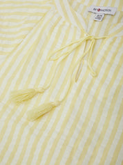Yellow and white striped fabric with tassels and a visible brand label.