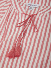 Red and white striped shirt with a tassel and brand label on a matching background