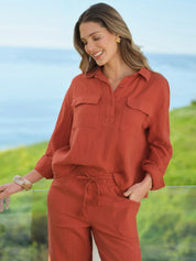 Woman wearing a red outfit with a scenic background