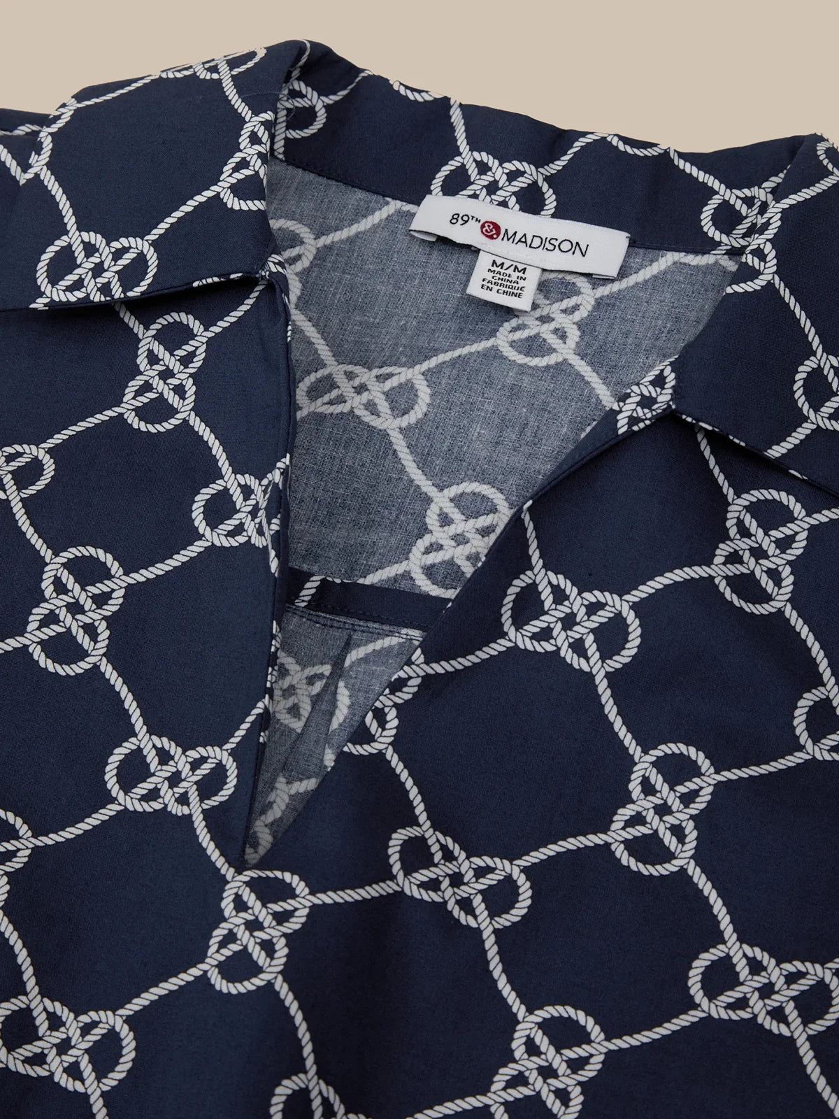 Navy shirt with white pattern and '89TH Madison' label on collar