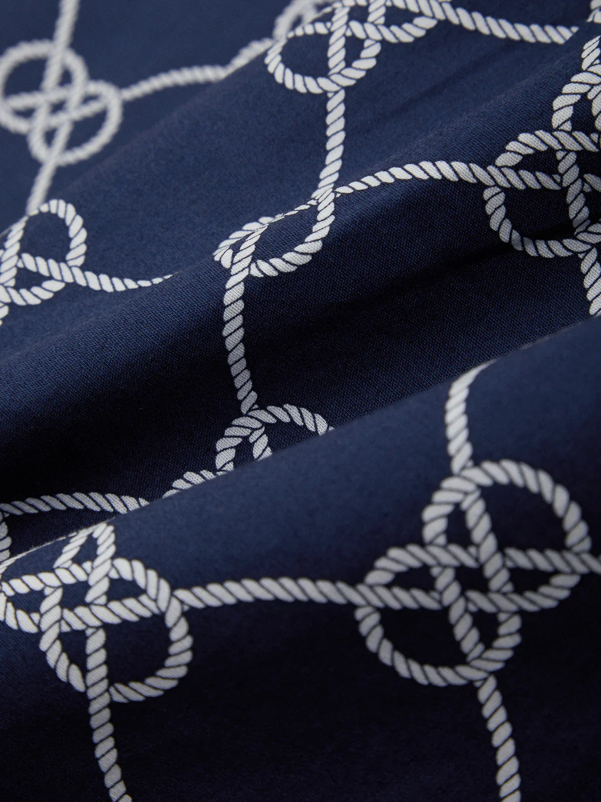 Navy blue fabric with white rope knot pattern
