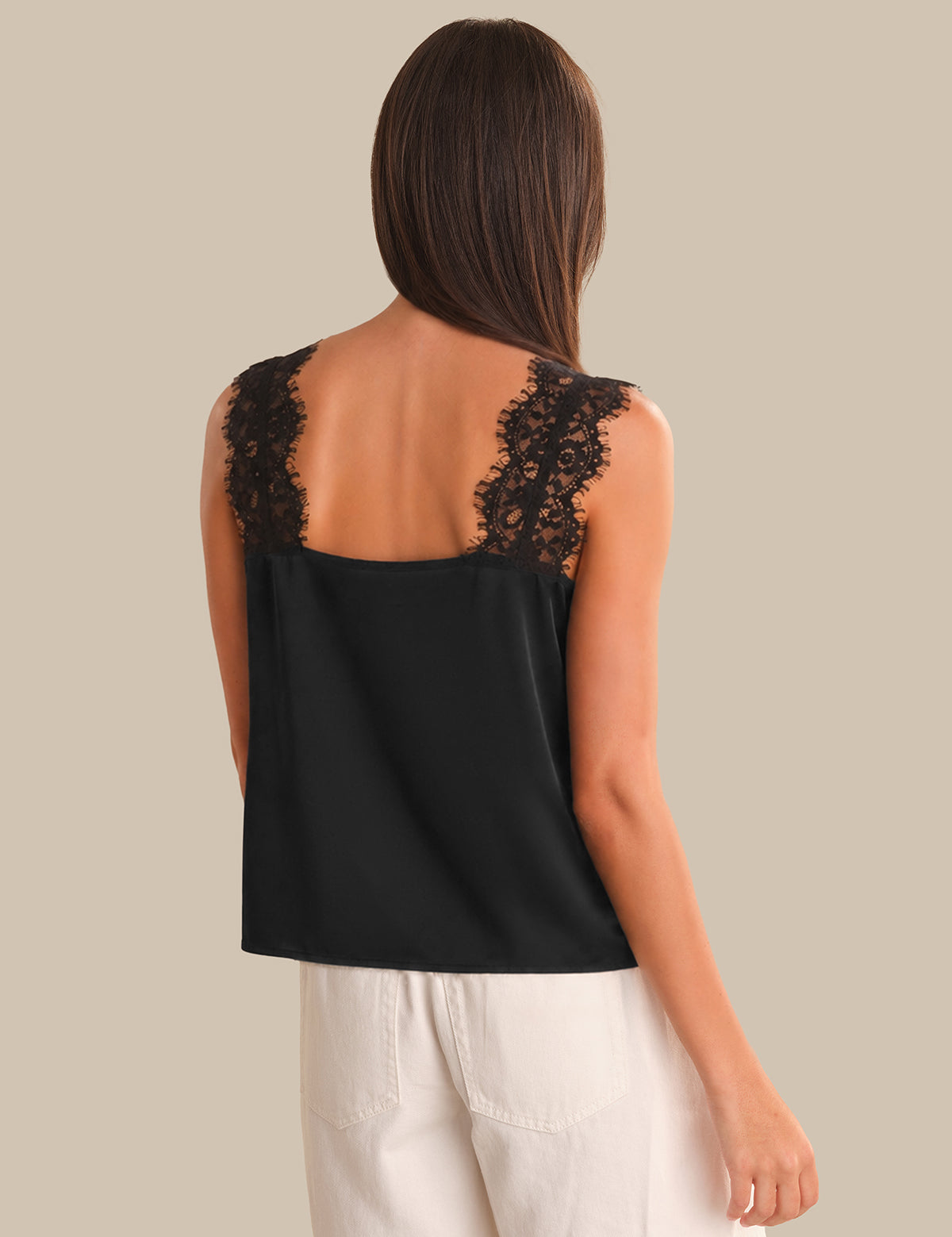 Black sleeveless top with lace details on a plain background